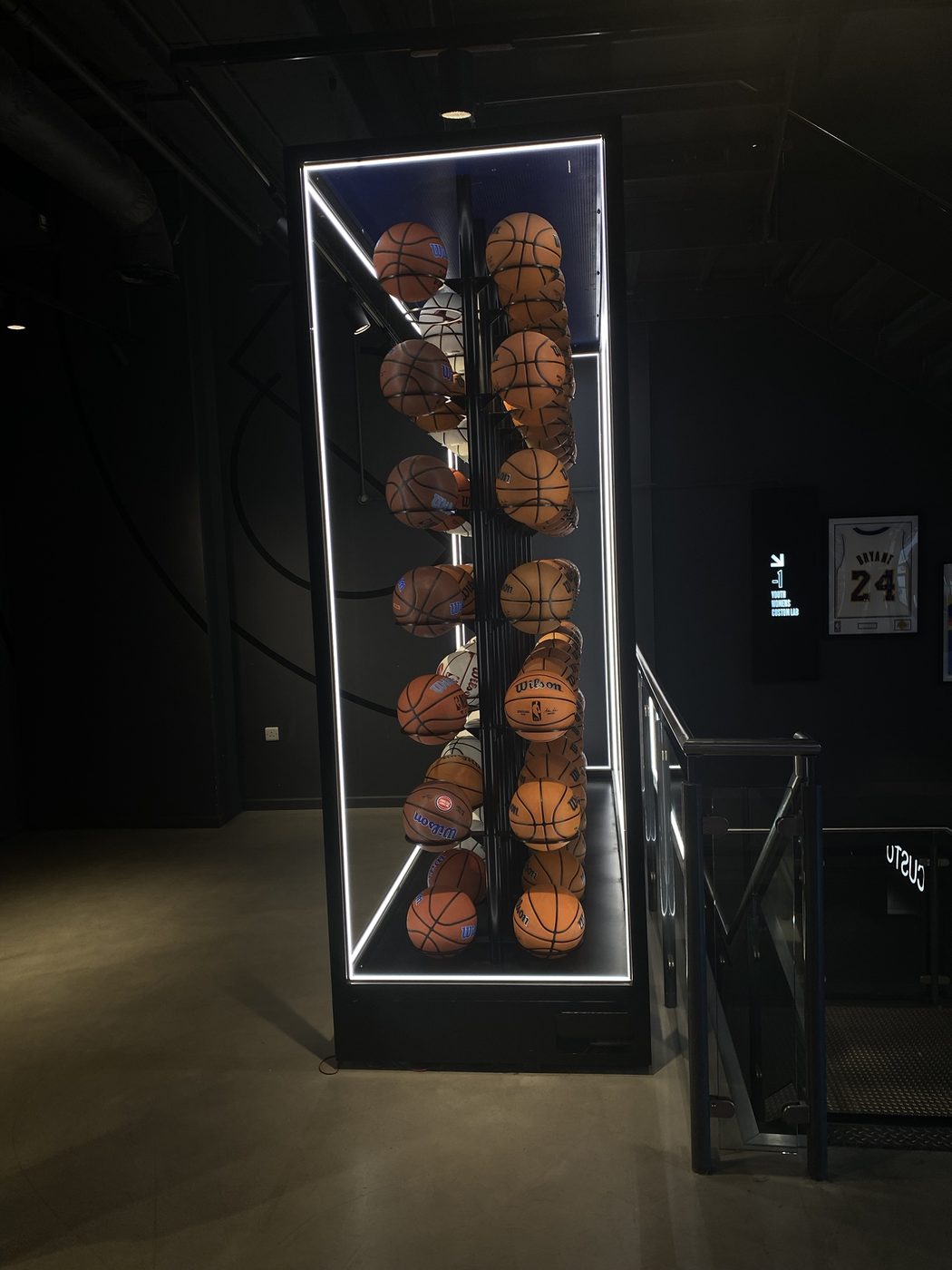 A glowing display case packed with basketballs